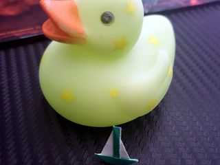 Miniature origami boat and giant bath duck!
