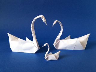 Origami swans couple and swanling